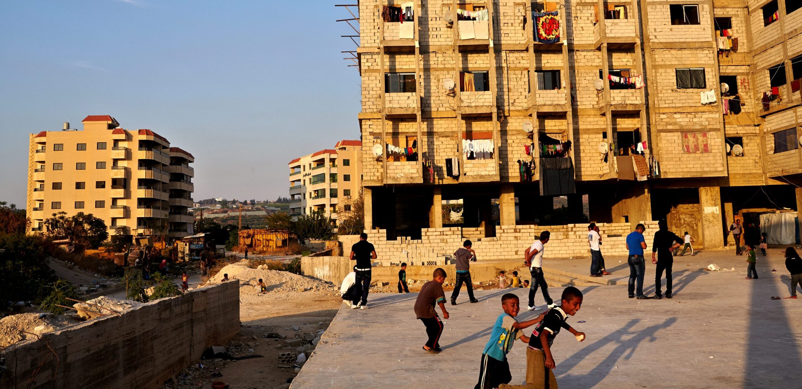 Syrian refugee children play outside a collective settlement in Lebanon.